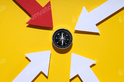 Preview: Dark compass on bright background, top view.