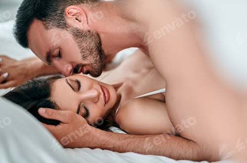Preview: The passionate man and woman playing in the bed.