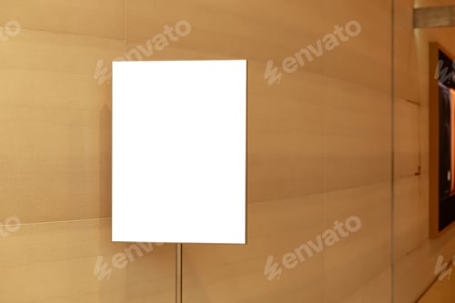 Preview: A blank display board is placed against a light-colored wall inside a building.
