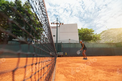 Preview: A girl playing tennis on a court