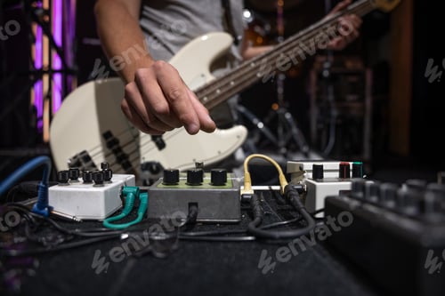 Preview: Close-up set of distortion effect pedals for guitar on stage.