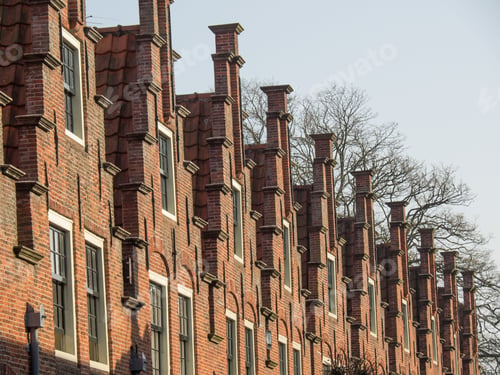 Preview: Row of traditional red brick buildings in the city Haarlem with canals in the Netherlands