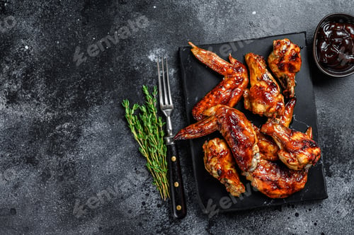 Preview: Hot Barbecue chicken wings with sauce bbq. Black background. Top view. Copy space