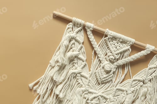 Preview: Macrame. Handmade macrame weaving and cotton threads on a rustic wooden stick.