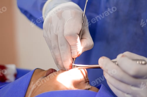 Preview: Closeup of a doctor performin surgery on a patient while the patientis sedated