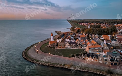 Preview: Urk Flevoland Netherlands sunset at the lighthouse and harbor of Urk Holland. Fishing village Urk
