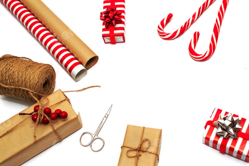 Preview: Flat-lay of decorations, ribbons, gift paper, wrapped gift on whire background