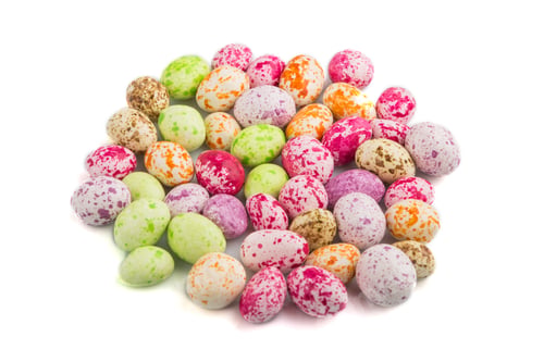 Preview: Pile of multicolored chocolate candies isolated on white background. close up, side view.