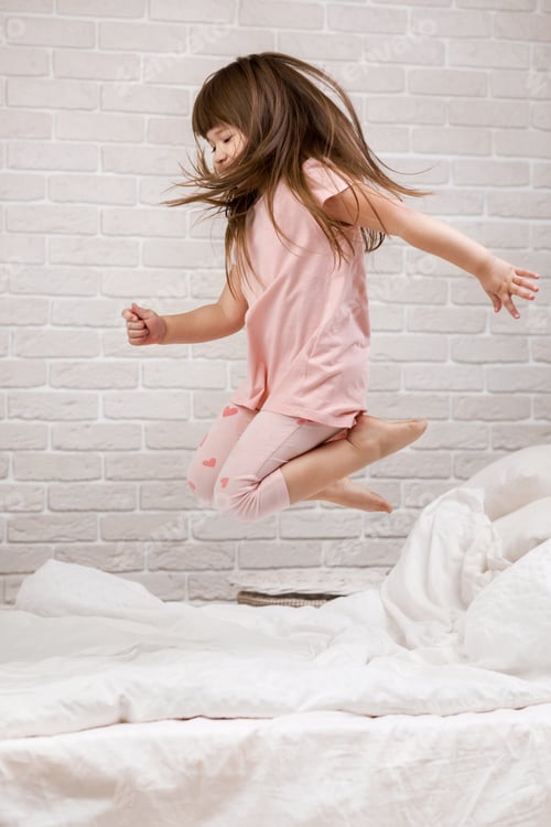 Preview: cute little child girl fooling around in bed