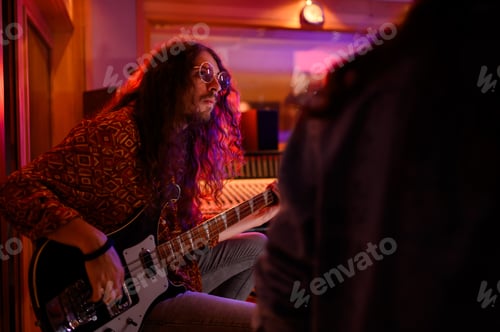 Preview: Portrait of professional guitarist playing bass at music recording studio