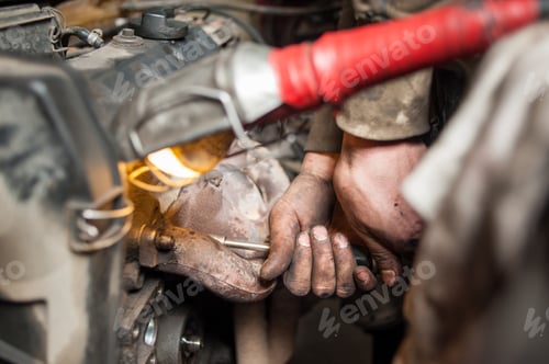 Preview: Hands of repairman mechanic working on engine using tool