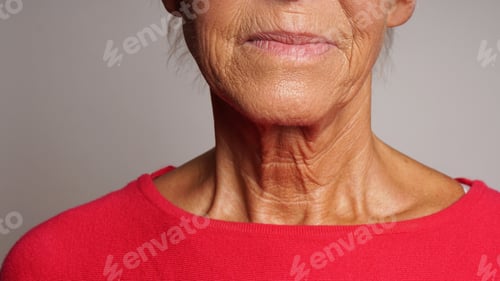 Preview: Closeup neck and chin of senior woman with skin wrinkles