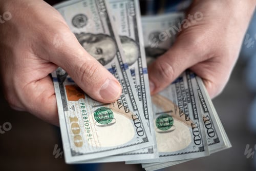 Preview: Close up male hand Counting and holding money us dollar.