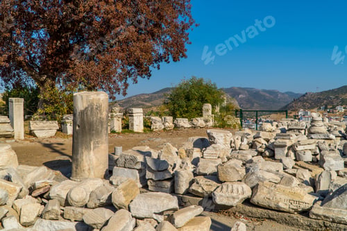 Preview: Ruins with a pile of large rocks & old town in the background