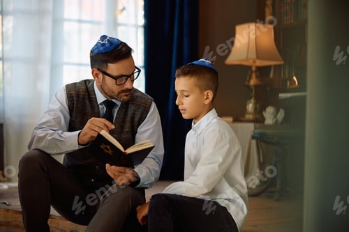 Preview: Jewish father reading Tanakh to his son at home.