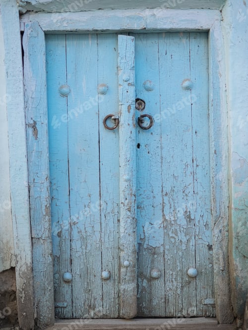 Preview: Aged wooden door in metal rivets