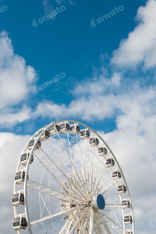 Preview: carousel wheel on a partly cloudy sky