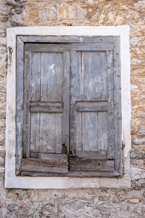 Preview: Old double closed wooden shutters. Vertical view.