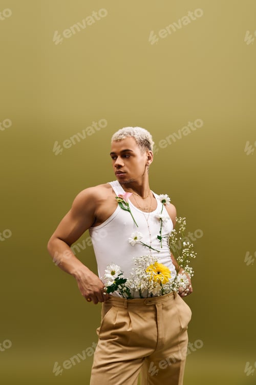 Preview: Young stylish man with dyed hair showcases trendy flower-inspired fashion in studio