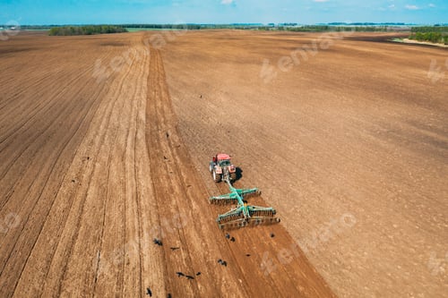 Preview: Aerial View. Tractor Plowing Field In Spring Season. Beginning Of Agricultural Spring Season