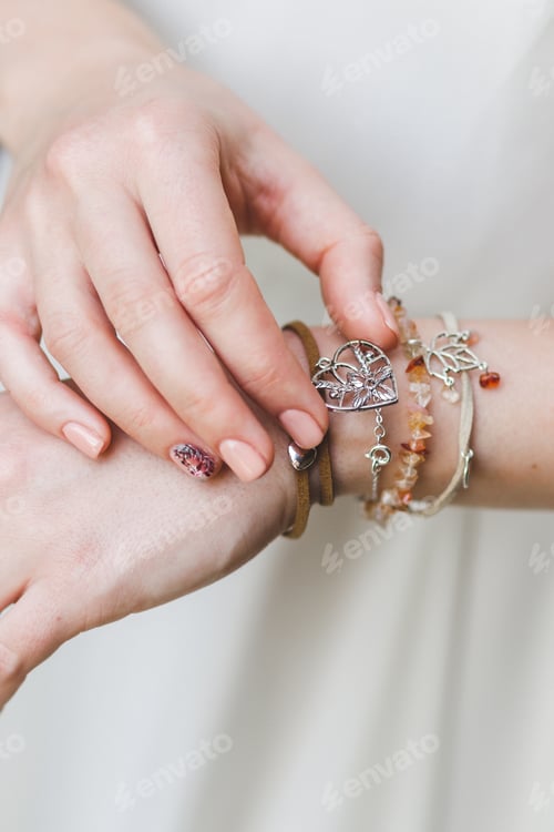 Preview: Woman hands with different bracelets and jewellery