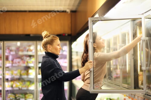 Preview: Women Choosing Frozen Food From A Supermarket Freezer