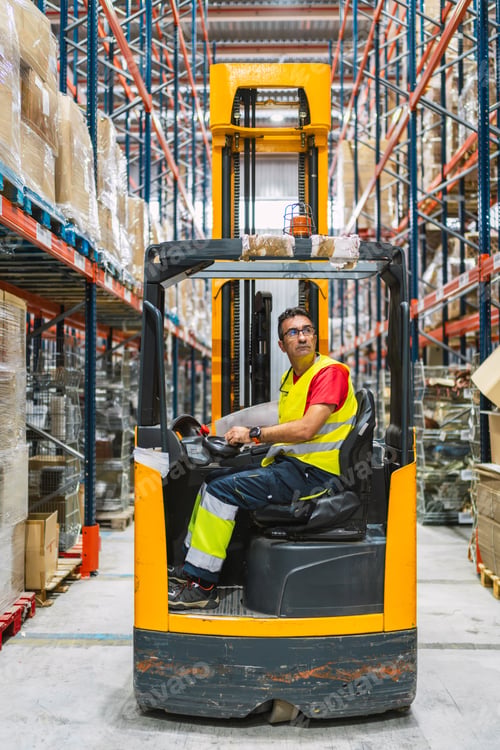Preview: Warehouse worker driving forklift arranging goods on shelves