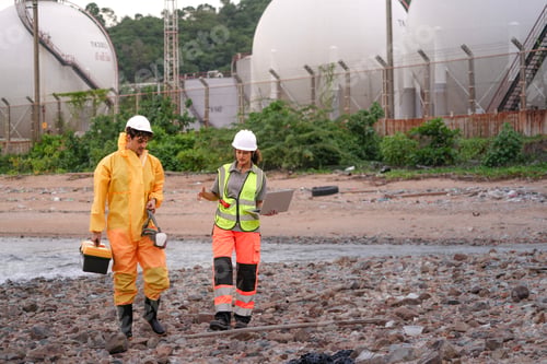Preview: Two environmental researchers walk back from shoreline testing.