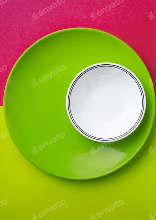 Preview: Vertical shot of a white small plate on a big green plate