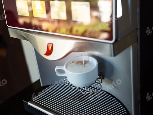 Preview: Milk Coffee Purring from Automatic Coffee Machine in White Cup
