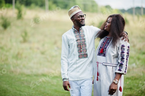 Preview: African couple in traditional clothes at park.