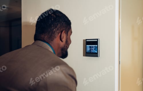 Preview: Businessman using face scanner to unlock door in office.
