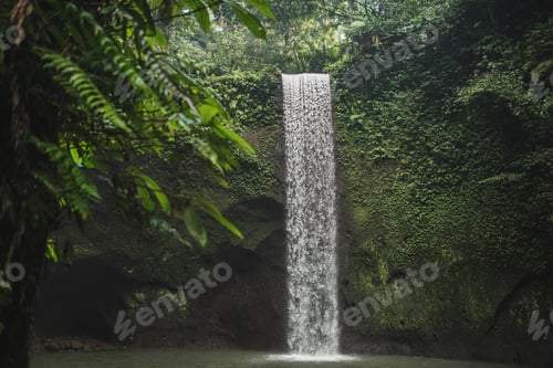 Preview: Small secret waterfall Tibumana in Bali, Indonesia. Popular tourist landmark in green lush jungle