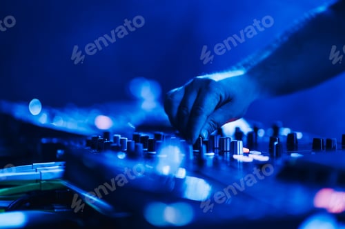 Preview: Dj hand using mixing console on live performance on a festival.