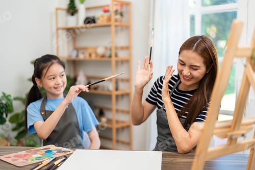 Preview: Joyful moments in art: Woman and girl playfully painting together