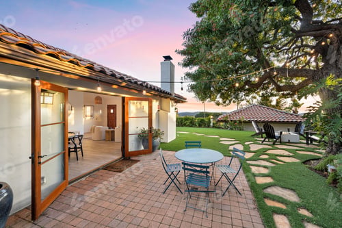 Preview: an outdoor patio with a table and chairs in front of the house