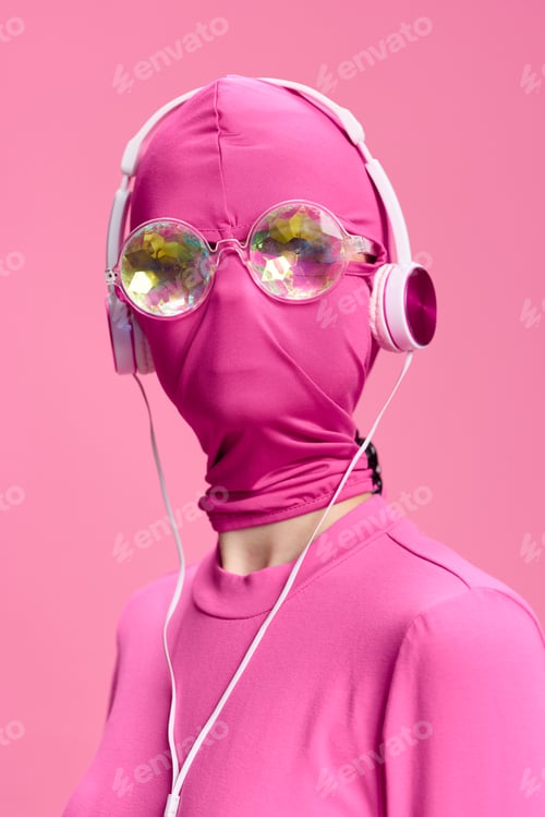 Preview: A crazy conceptual portrait of a young woman without a face mask on a pink background and wearing