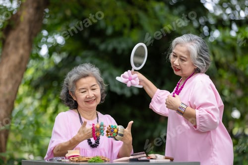 Preview: Two Elderly Women Choosing Accessories Together Outdoors