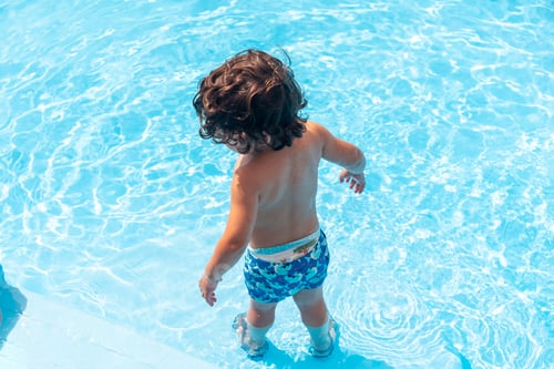 Preview: A boy having fun in the pool of the village of La Caleta by the sea in El Hierro, Canary Islands