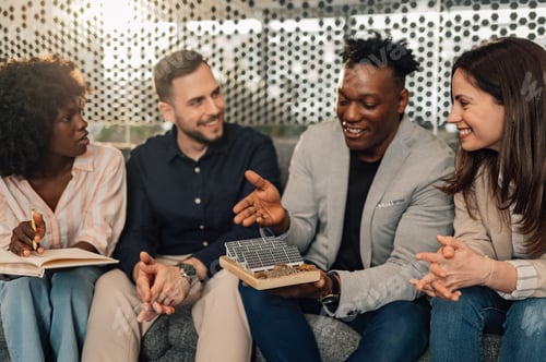 Preview: Diverse businessman presenting solar panels to his team at office.