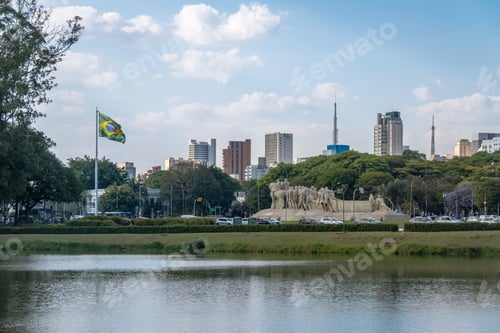 Preview: Bandeiras Monument, Ibirapuera Park and city skyline with brazilian flag - Sao Paulo, Brazil
