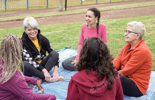 Preview: Multi generational women having fun talking and sitting at city park