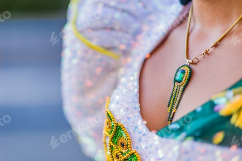 Preview: Woman wearing traditional dress and necklace celebrating dia de la hispanidad. Dia de la hispanidad