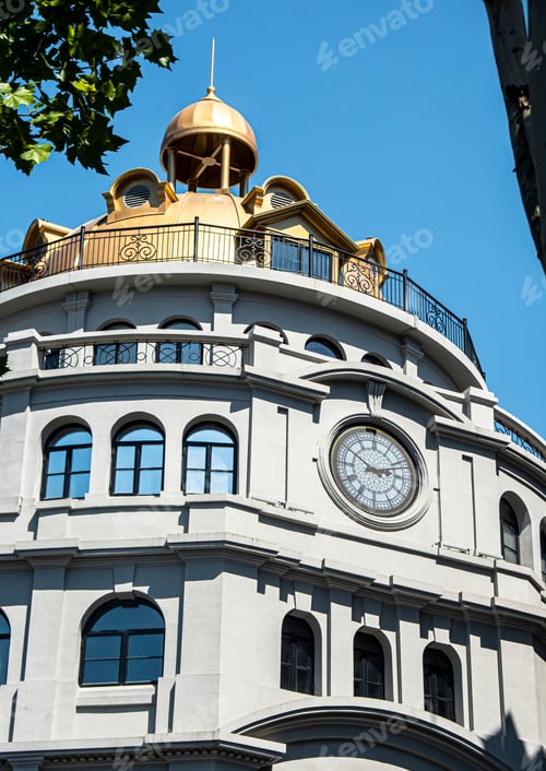 Preview: Elegant building with golden dome and clock tower.