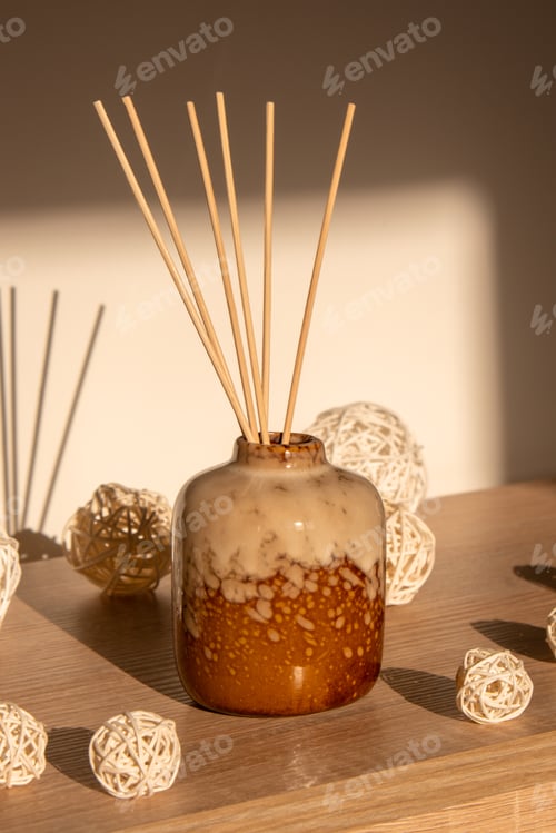 Preview: Cozy home decorations aroma reed diffuser in the living room. Home comfort concept. Bottle container
