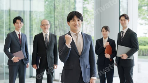 Preview: Smiling businessman posing with fist