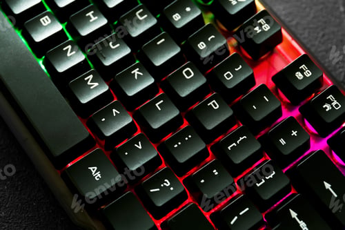 Preview: Modern keyboard with RGB lighting on grey table, closeup
