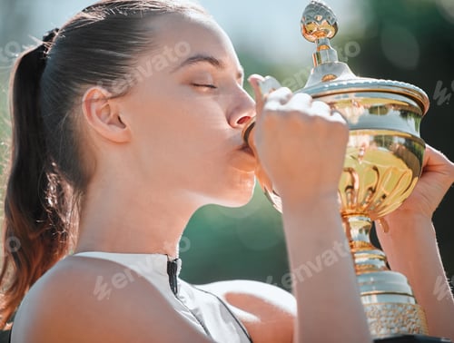 Preview: Sport, winner and woman kiss trophy after tennis game success with sports achievement and fitness o