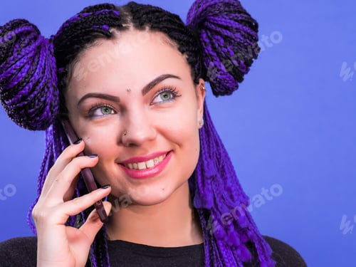 Preview: Adorable hipster caucasian woman with african colorful braids hairstyle talking with smartphone