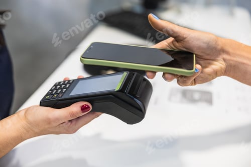 Preview: Customer completing contactless payment using smartphone at terminal